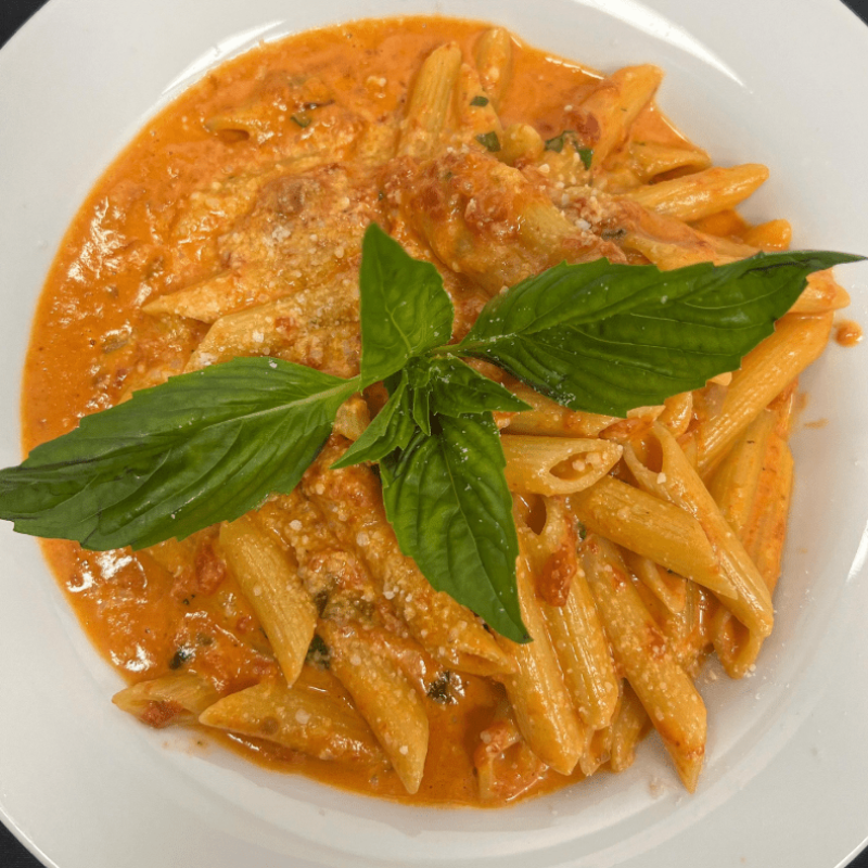 penne pasta dish with basil garnish
