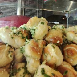 pile of garlic knots in serving window in restaurant
