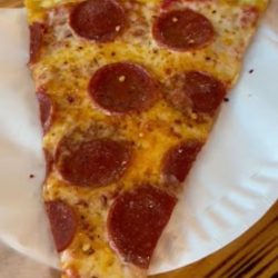 slice of pepperoni pie in restaurant