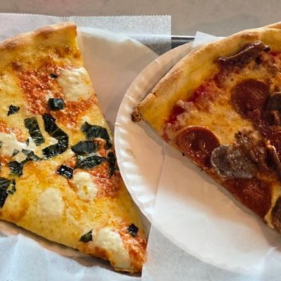 pizza by the slice served on paper plates