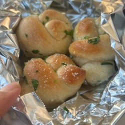 close up of garlic knots in foil packet