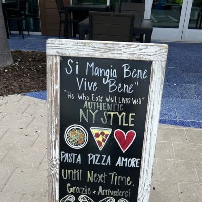 Sign outside Sal's Pizza Bar, showing NY-style pizza