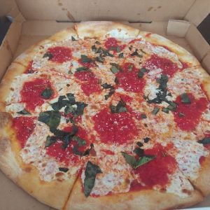 pizza pie with fresh tomatos and basil